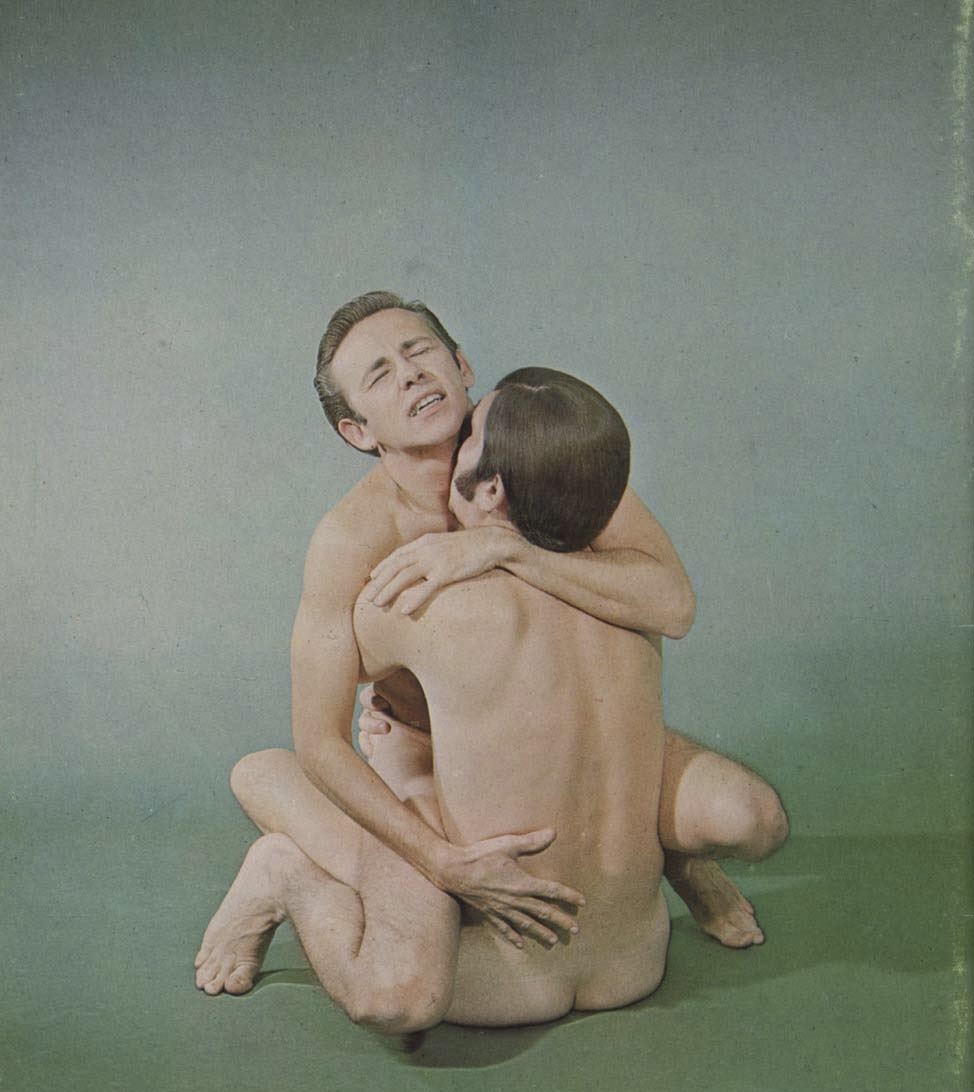Interior photograph from My Oh My, Volume 1, showing two men embracing
